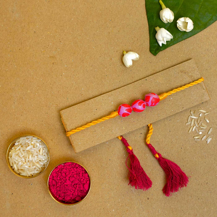 Handmade Pink & Yellow Potli Upcycled Fabric Rakhi With Roli Chawal