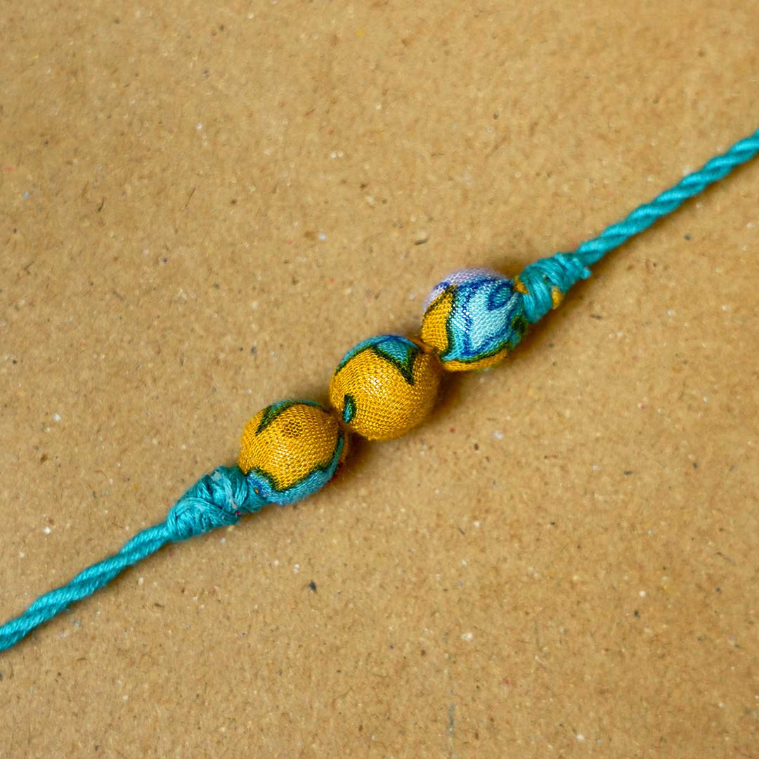 Handmade Turquoise Upcycled Fabric  Rakhi  With Roli Chawal