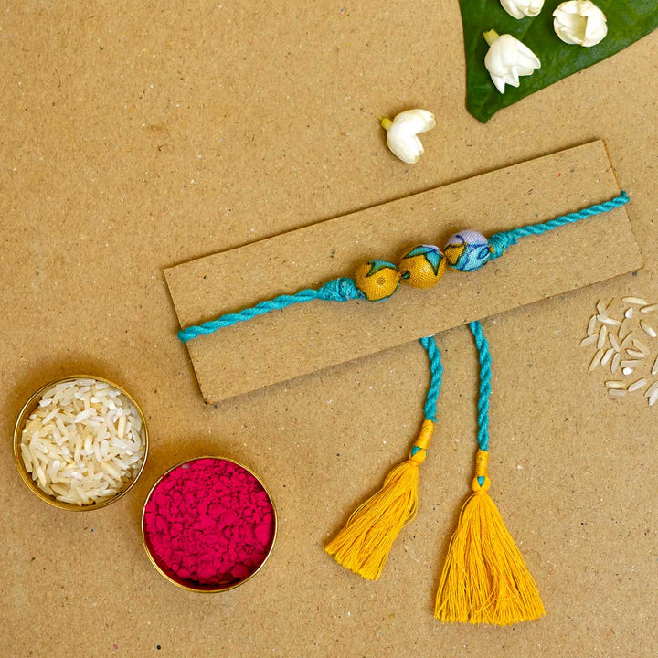 Handmade Turquoise Upcycled Fabric  Rakhi  With Roli Chawal