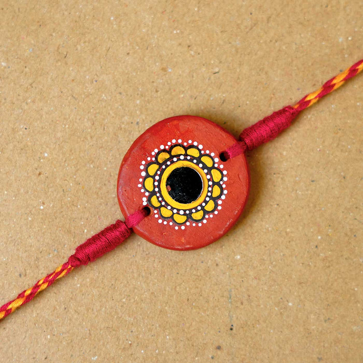 Hand-painted Suraj Terracotta Rakhi  With Roli Chawal