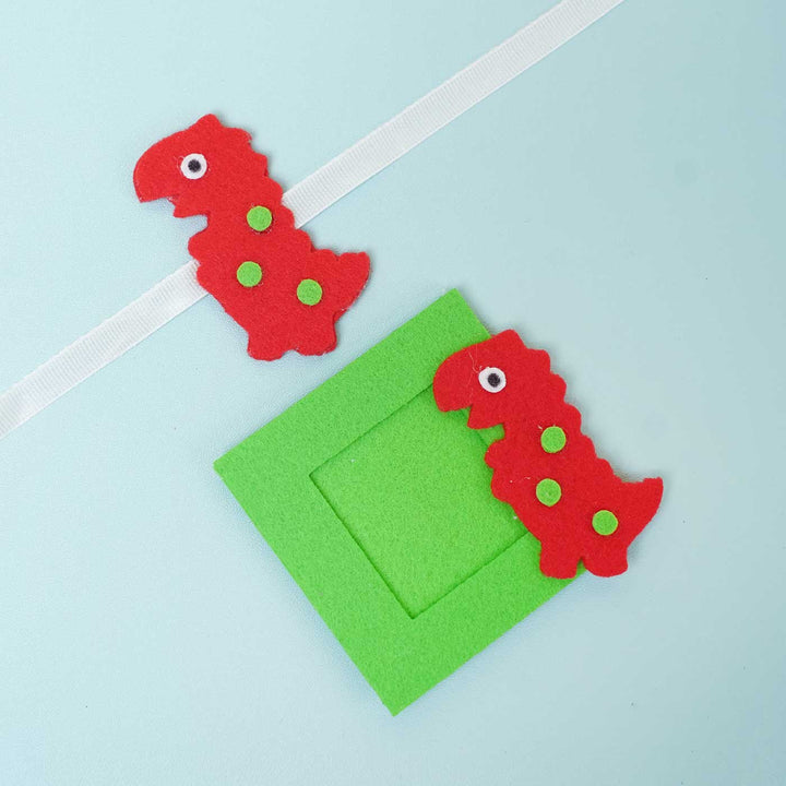 Handmade Red Dinosaur Felt Rakhi & Photoframe Magnet with Chocolates & Roli Chawal