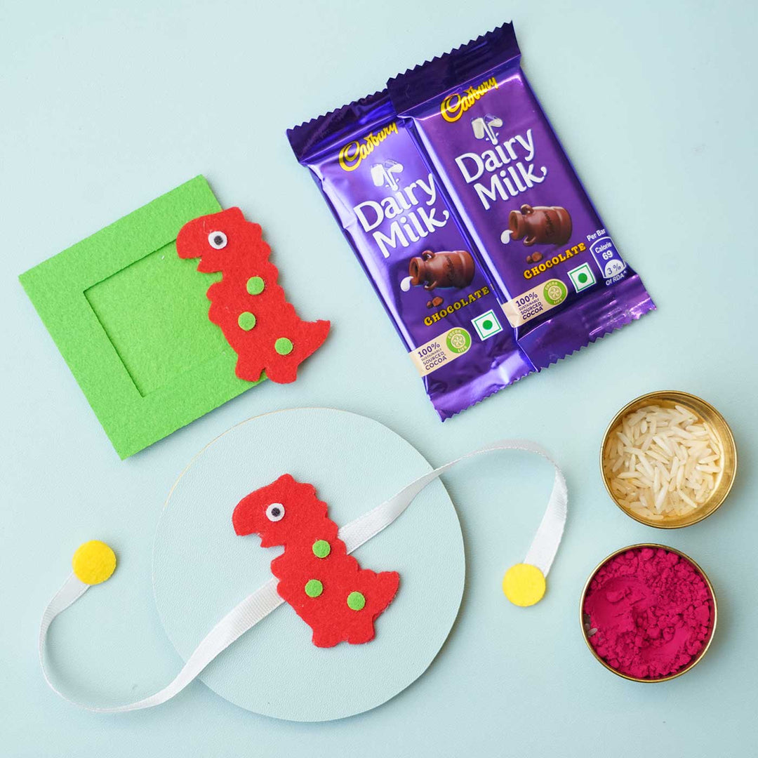 Handmade Red Dinosaur Felt Rakhi & Photoframe Magnet with Chocolates & Roli Chawal