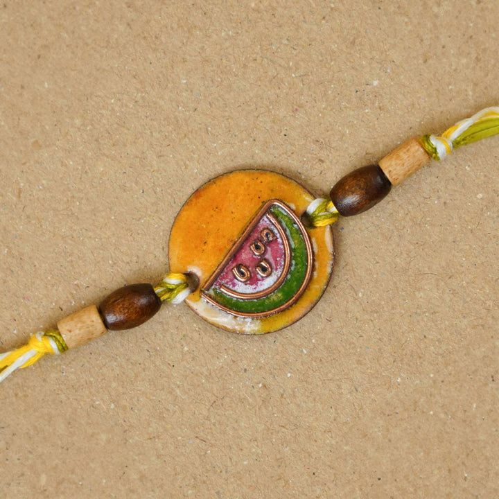 Handmade Tarbooz Red Copper Enamel Rakhi With Chocolates & Roli Chawal