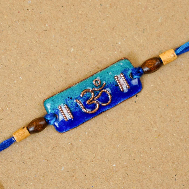 Handmade Rectangle Om Copper Enamel Rakhi With Chocolates & Roli Chawal