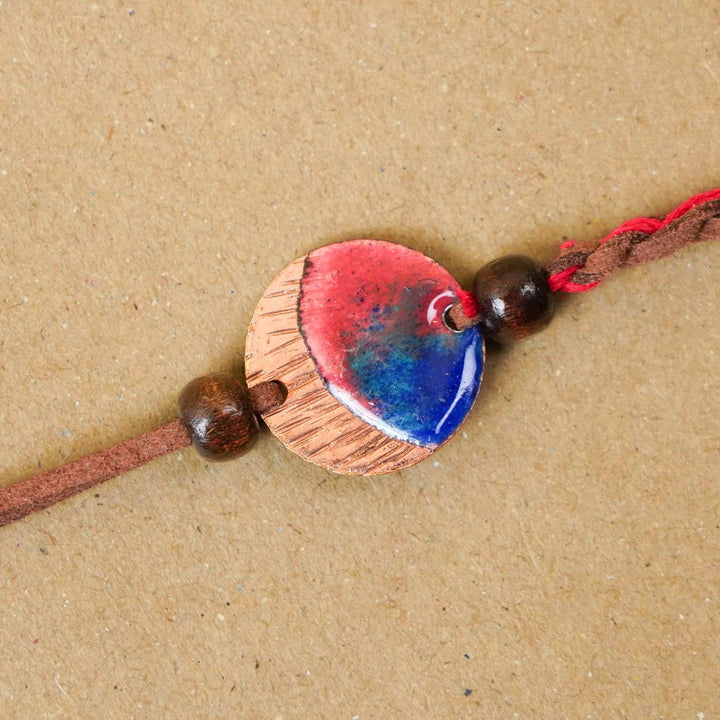 Handmade Rudra Textured Red Copper Enamel Rakhi With Chocolates & Roli Chawal