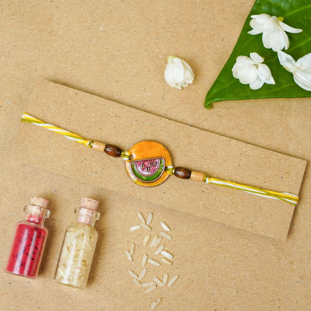 Handmade Tarbooz Red Copper Enamel Rakhi With Chocolates & Roli Chawal