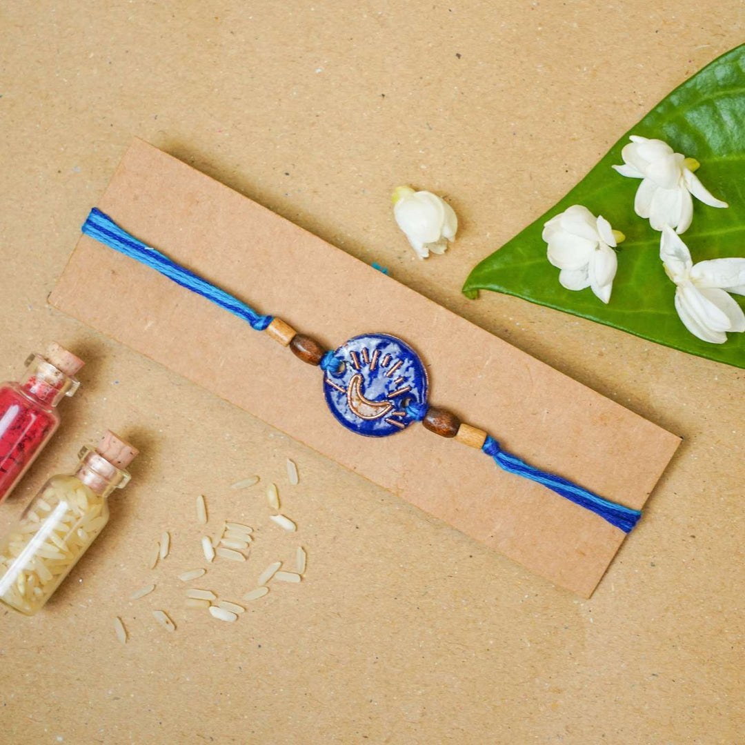 Handmade Chanda Blue Copper Enamel Rakhi With Chocolates & Roli Chawal