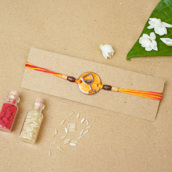 Handmade Wine O Clock Copper Enamel Rakhi With Chocolates & Roli Chawal