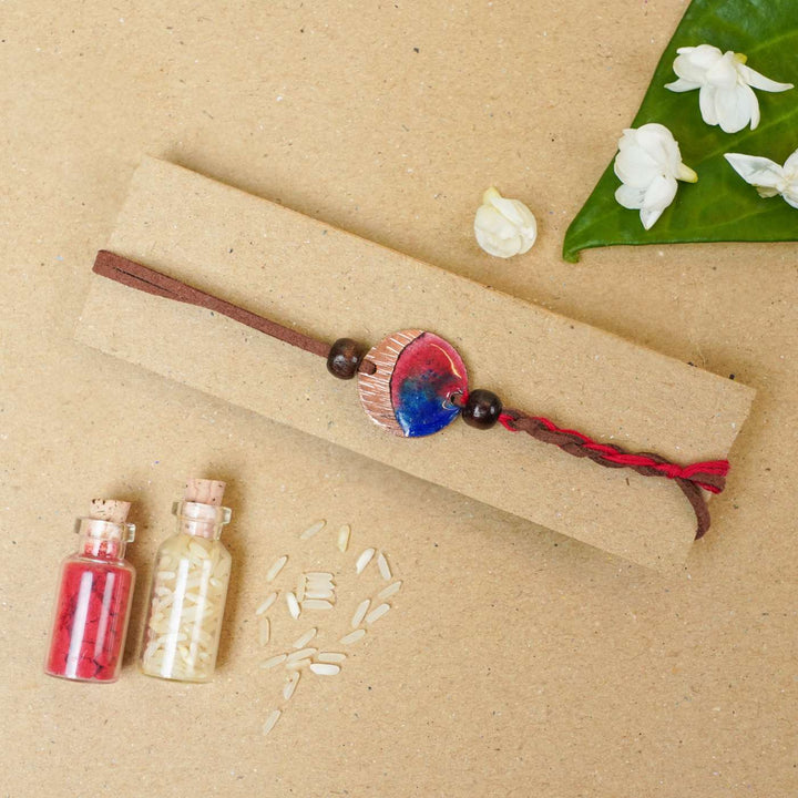 Handmade Rudra Textured Red Copper Enamel Rakhi With Chocolates & Roli Chawal