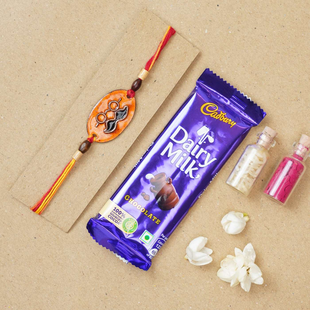 Handmade Mooch Copper Enamel Rakhi With Chocolates & Roli Chawal