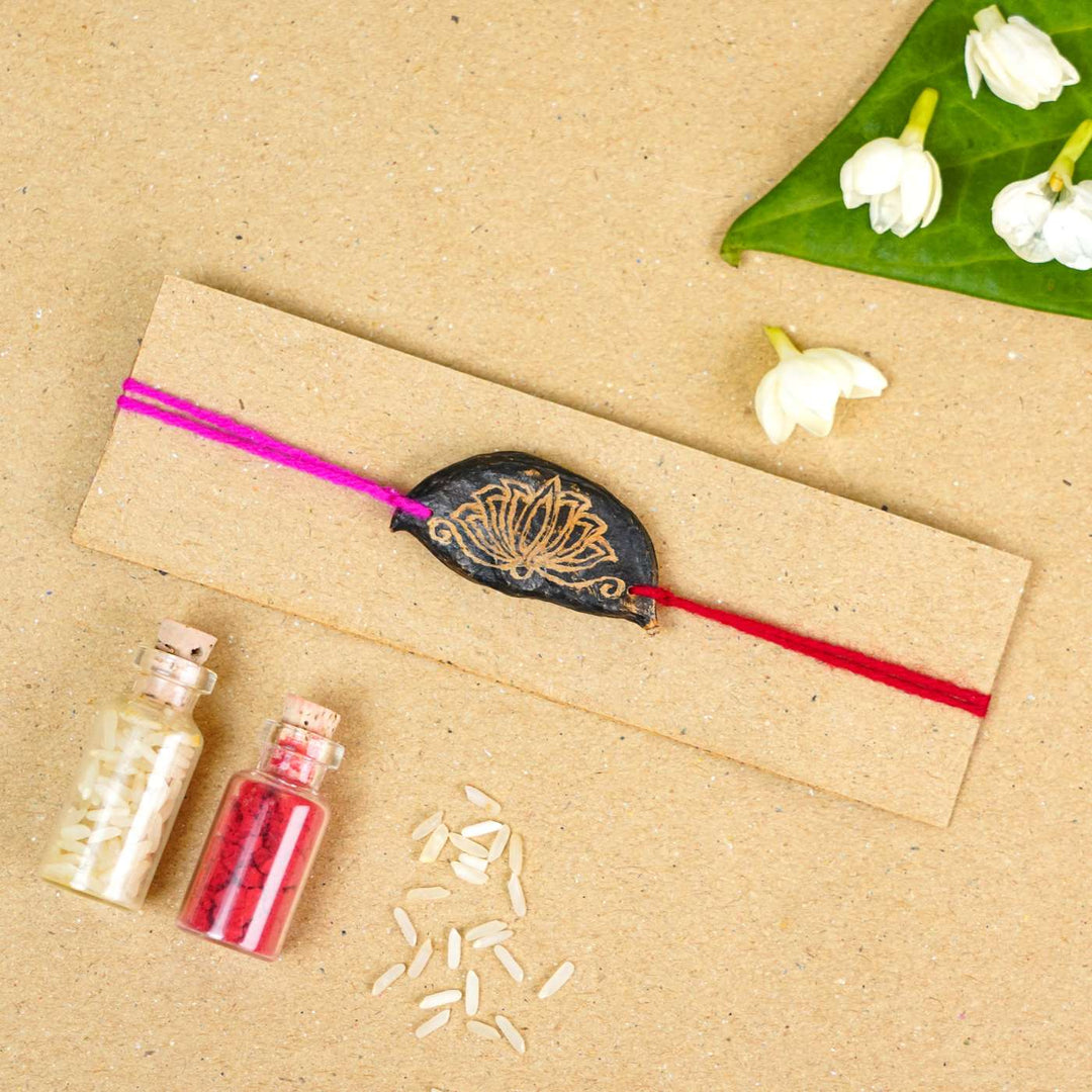 Handmade Plantable Painted Lotus Seed Rakhi With Roli Chawal