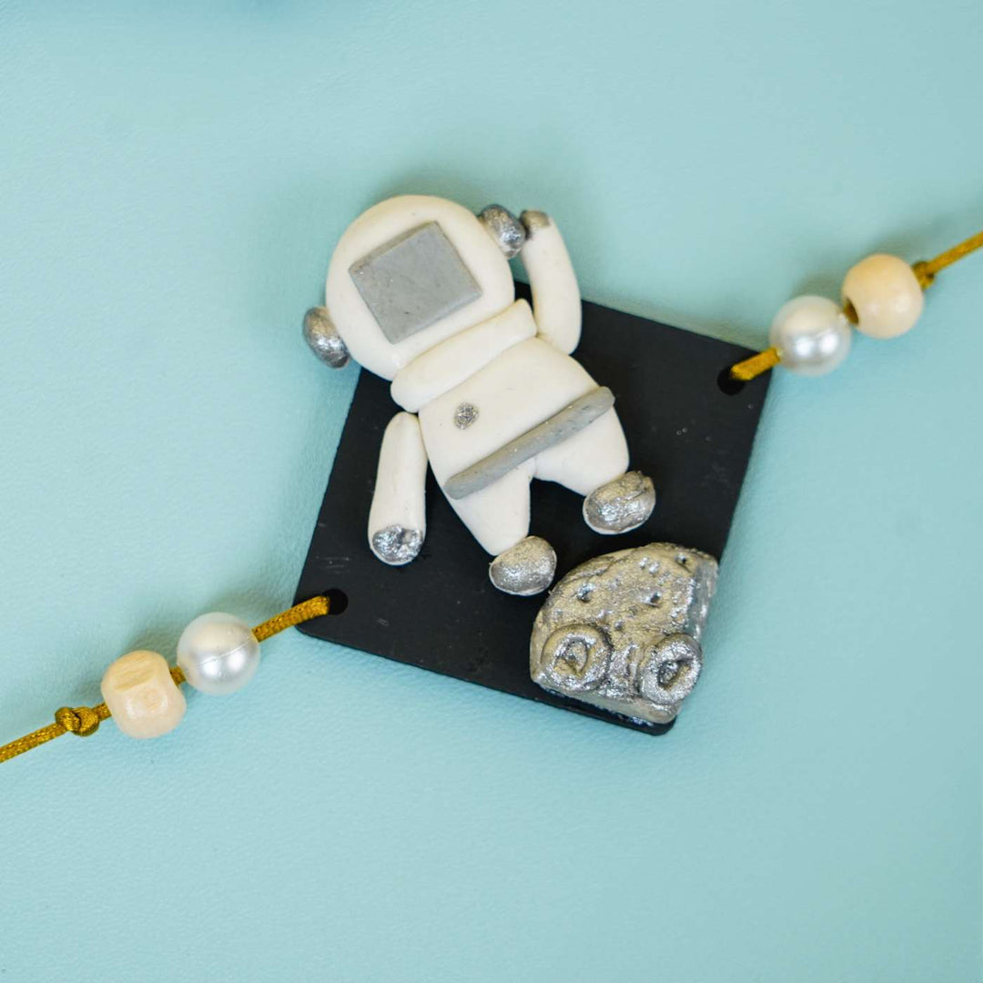 Handmade Miniature Clay Astronaut Kids Rakhi With Roli Chawal