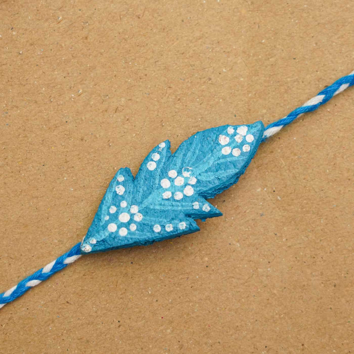 Handmade Ecofriendly Blue Feather Recycled Paper Rakhi With Roli Chawal