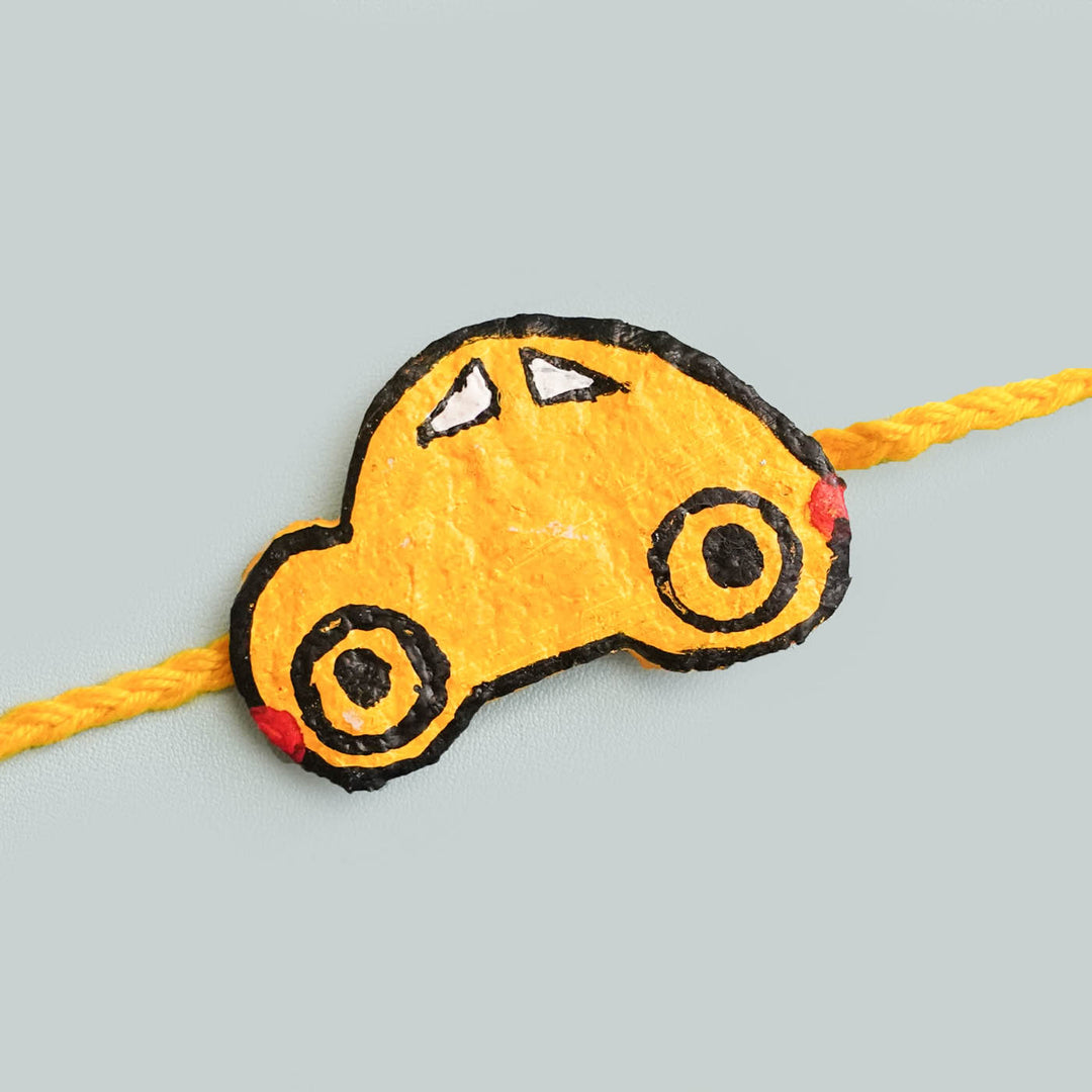 Handmade Ecofriendly Yellow Car Recycled Paper Rakhi With Roli Chawal