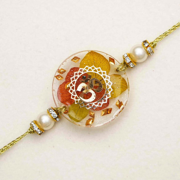 Handmade Resin Round Om Preserved Flower Rakhi With Roli Chawal