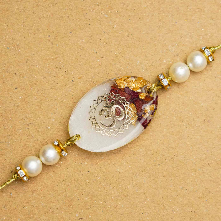 Handmade Resin Oval Om Preserved Flower Rakhi With Roli Chawal