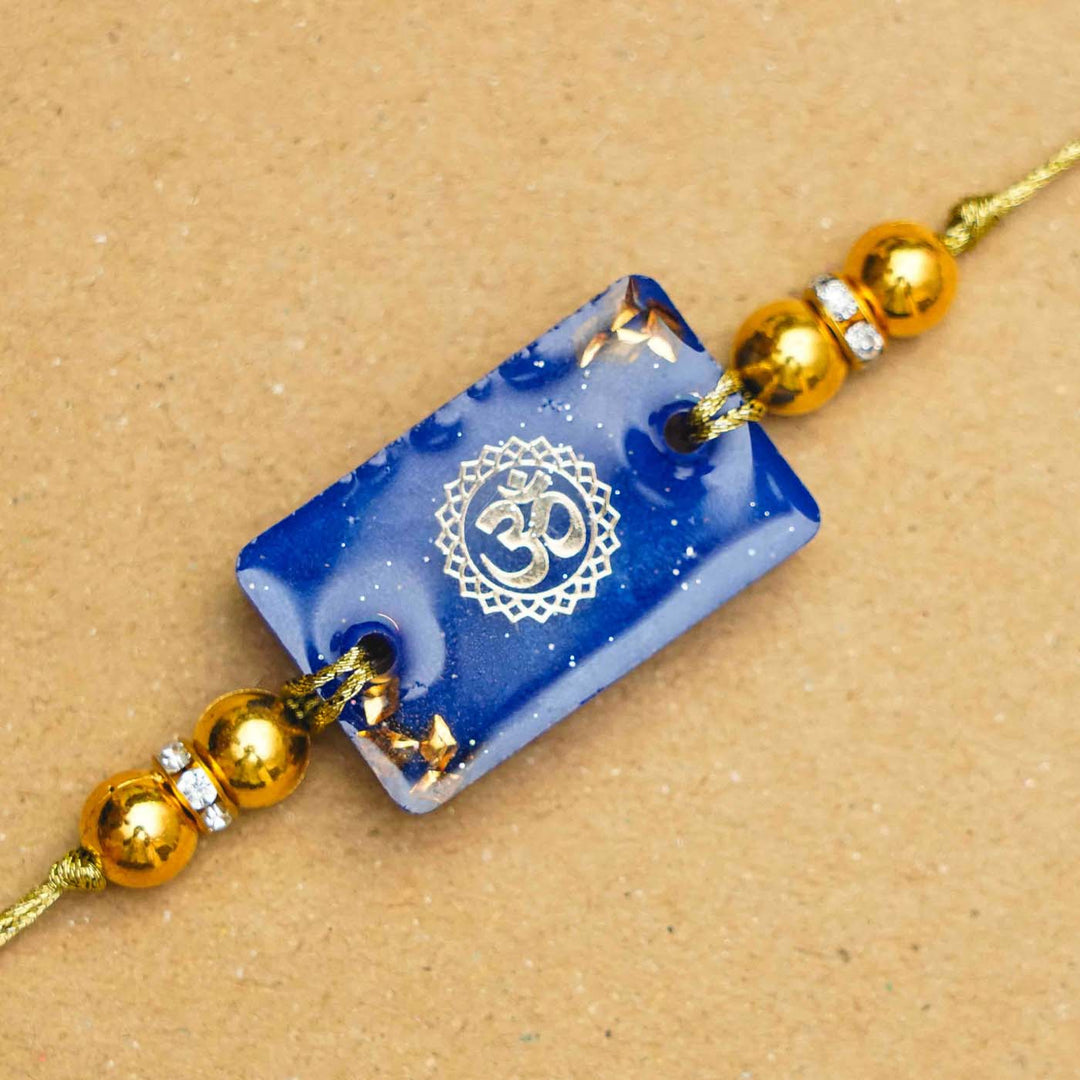 Handmade Resin Rectangle Blue Om Rakhi With Roli Chawal