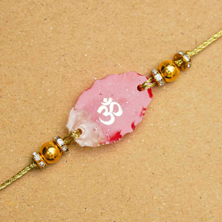 Handmade Resin Oval Om Rakhi With Roli Chawal