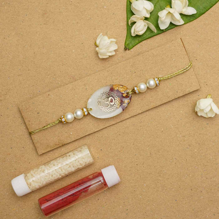 Handmade Resin Oval Om Preserved Flower Rakhi With Roli Chawal