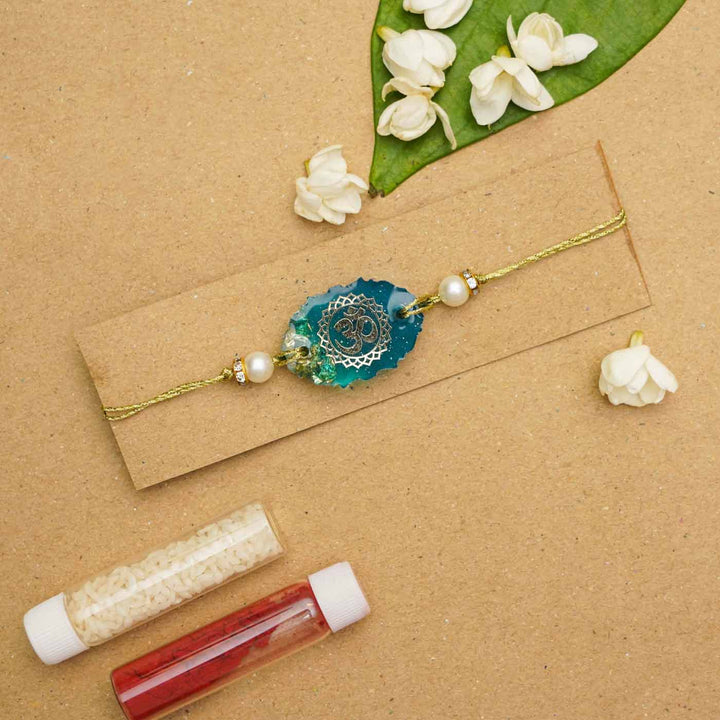 Handmade Resin Oval Om Rakhi With Roli Chawal