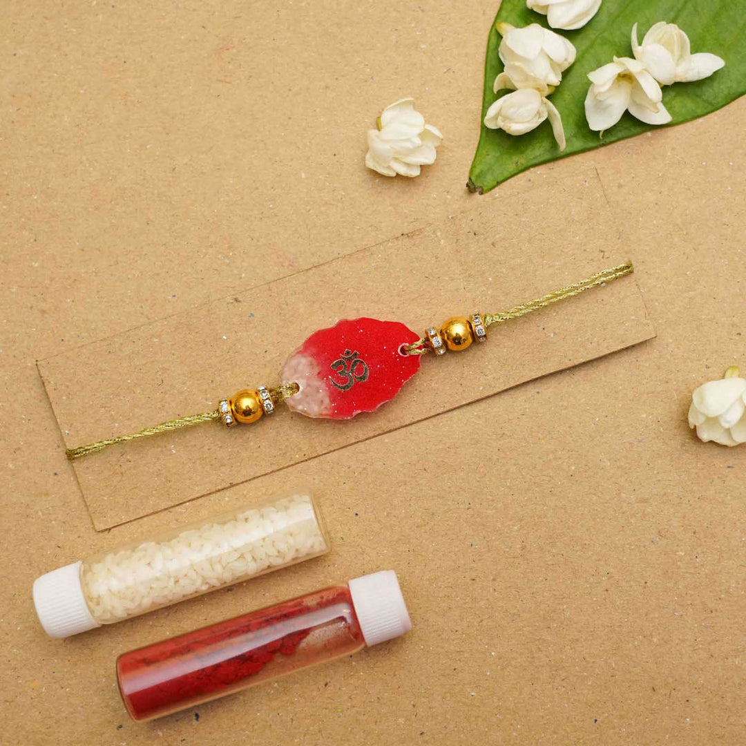 Handmade Resin Oval Om Rakhi With Roli Chawal