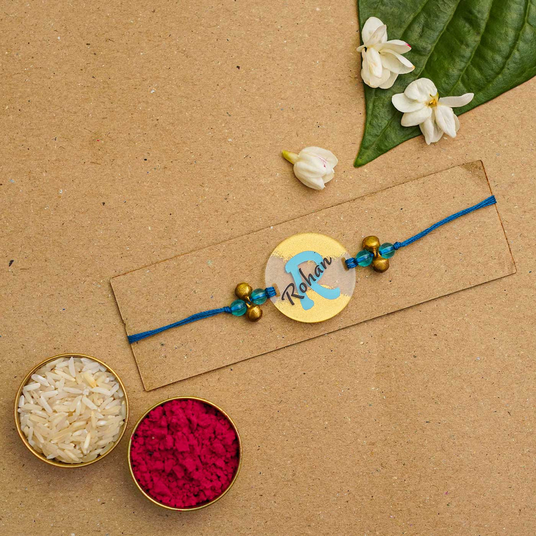 Personalized Handmade Name Golden Acrylic Rakhi With Roli Chawal