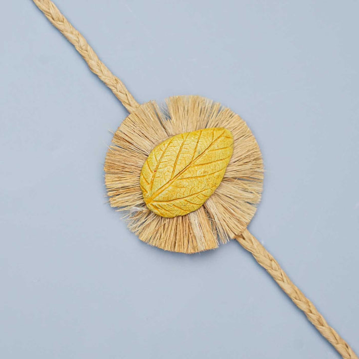 Handmade Papier Mache Yellow Leaf Rakhi With Roli Chawal