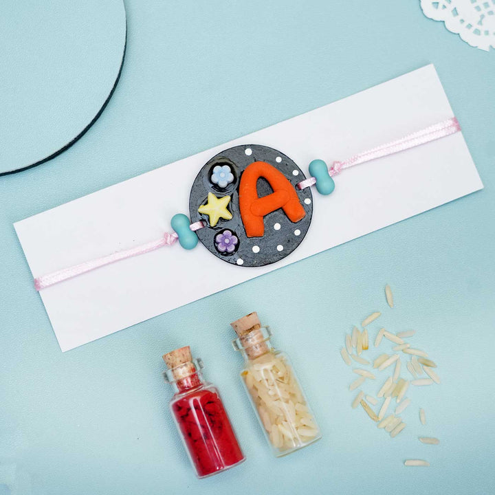 Personalized Hand-painted Alphabet Rakhi With Roli Chawal