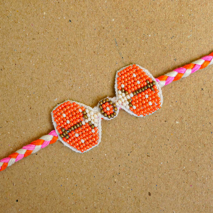 Reusable Beaded Orange Bug Rakhi With Roli Chawal