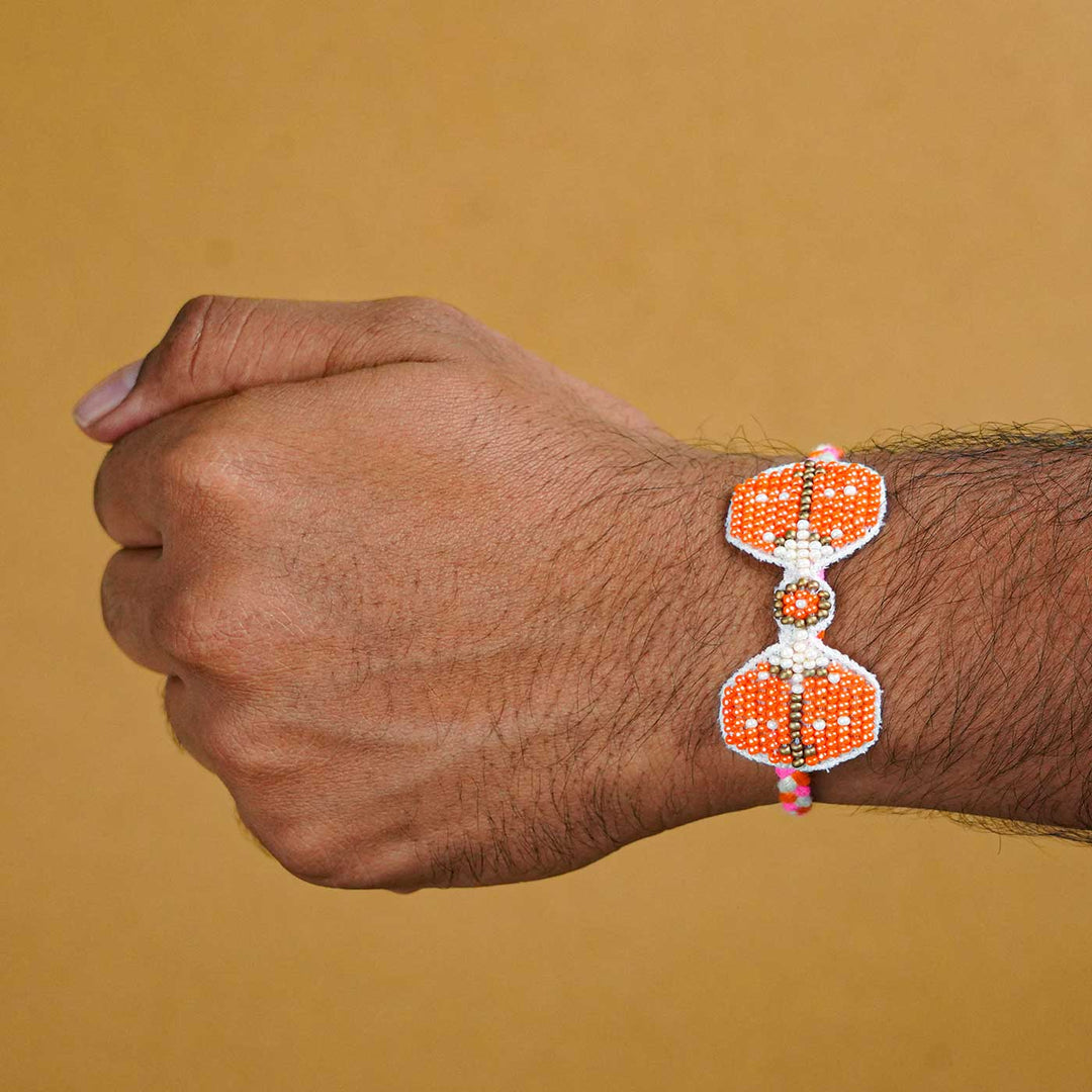 Reusable Beaded Orange Bug Rakhi With Roli Chawal