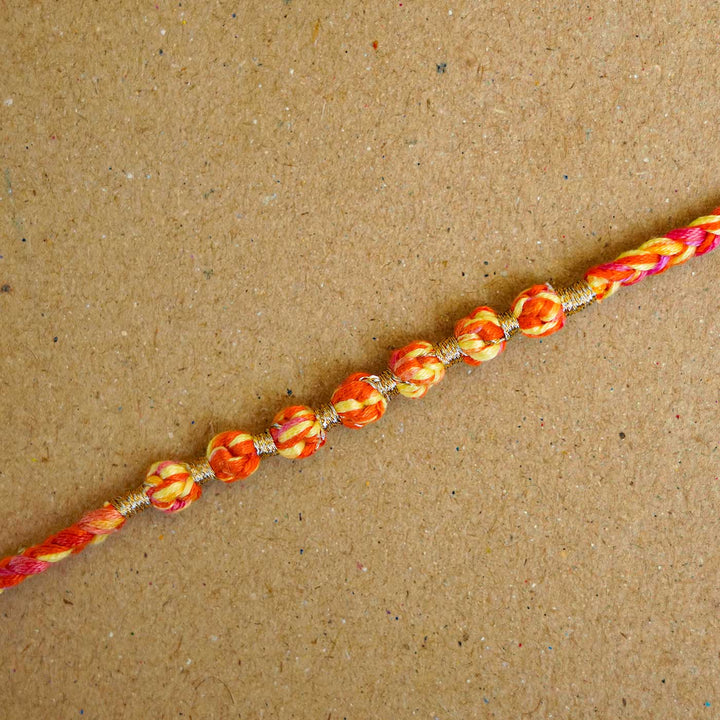 Reusable Beaded Orange Ombre Knot Rakhi With Roli Chawal