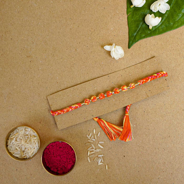 Reusable Beaded Orange Ombre Knot Rakhi With Roli Chawal