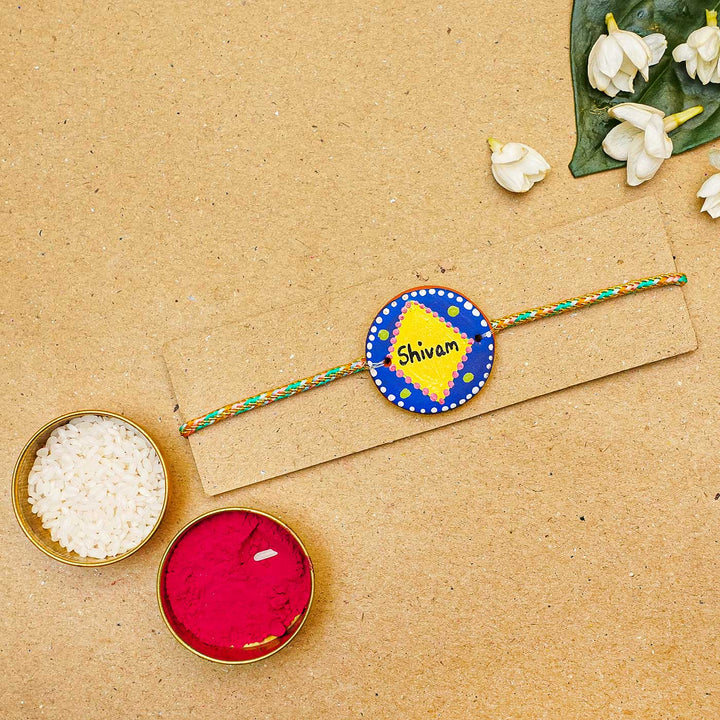 Personalized Terracotta Dark Blue & Yellow Rakhi With Roli Chawal