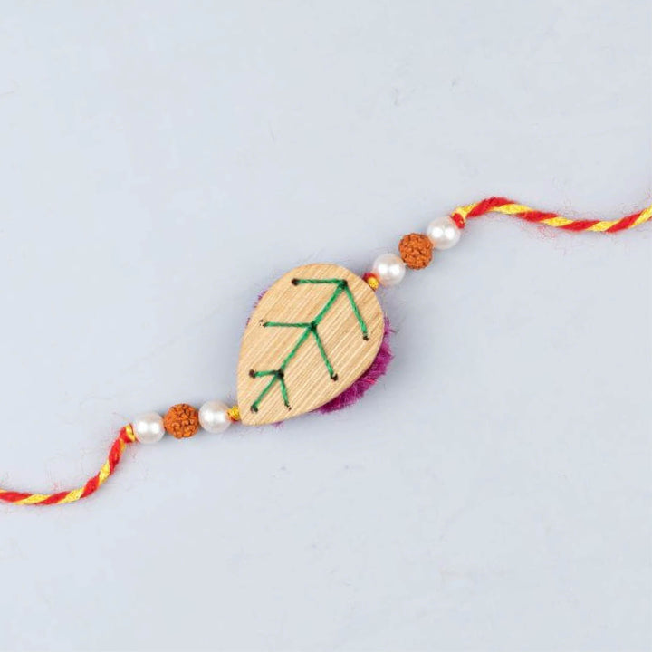 Handcrafted Bamboo Leaf-shaped Rakhi With Roli Chawal