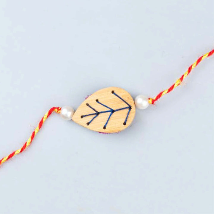 Handcrafted Bamboo Leaf-shaped Rakhi With Roli Chawal