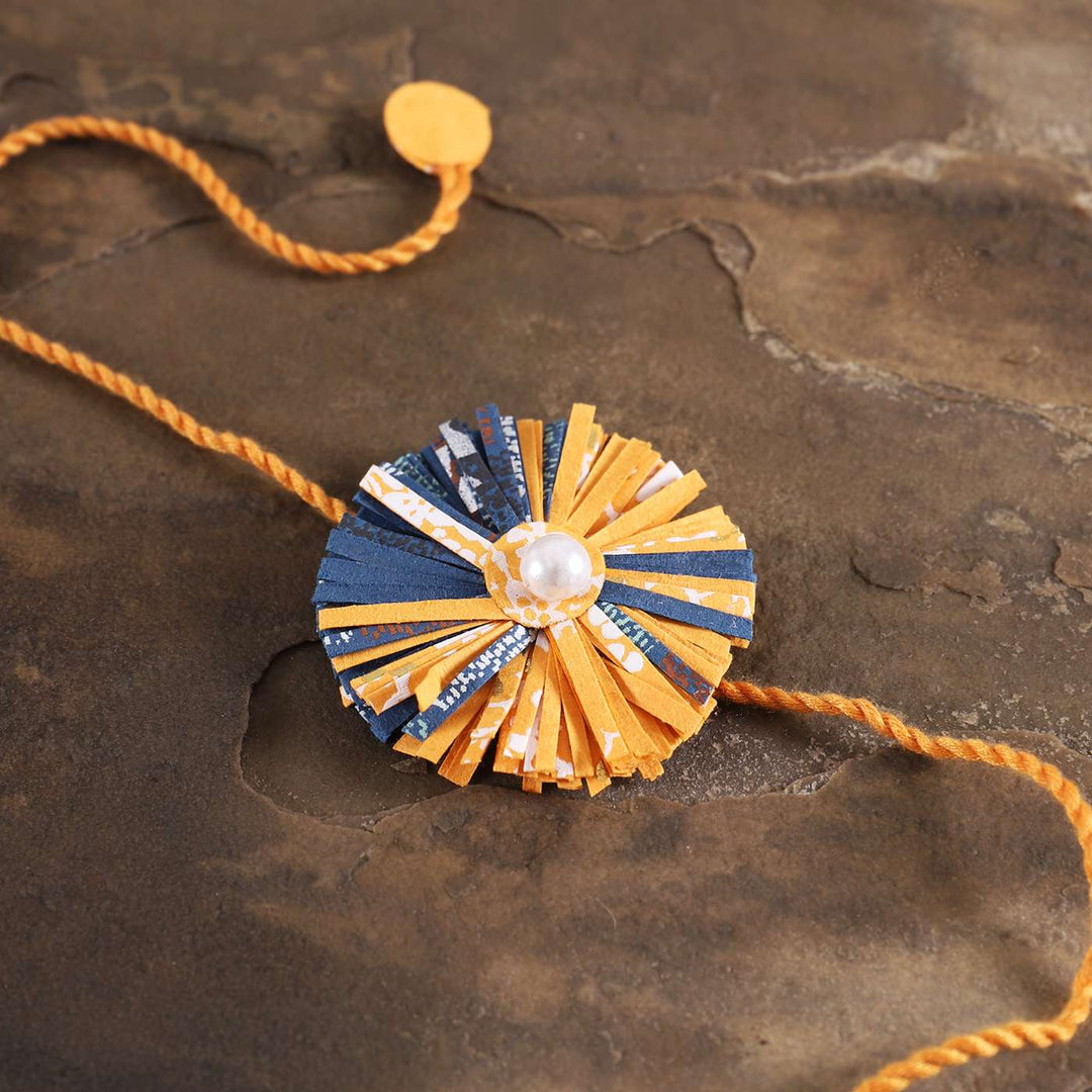 Handmade Ecofriendly Yellow Recycled Paper Rakhi With Roli Chawal