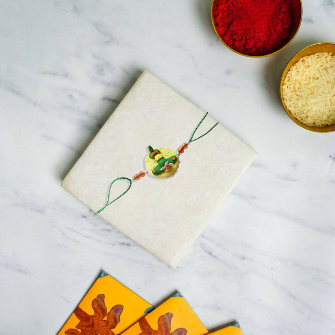 Handmade Porcelain Clay Themed Rakhi With Roli Chawal