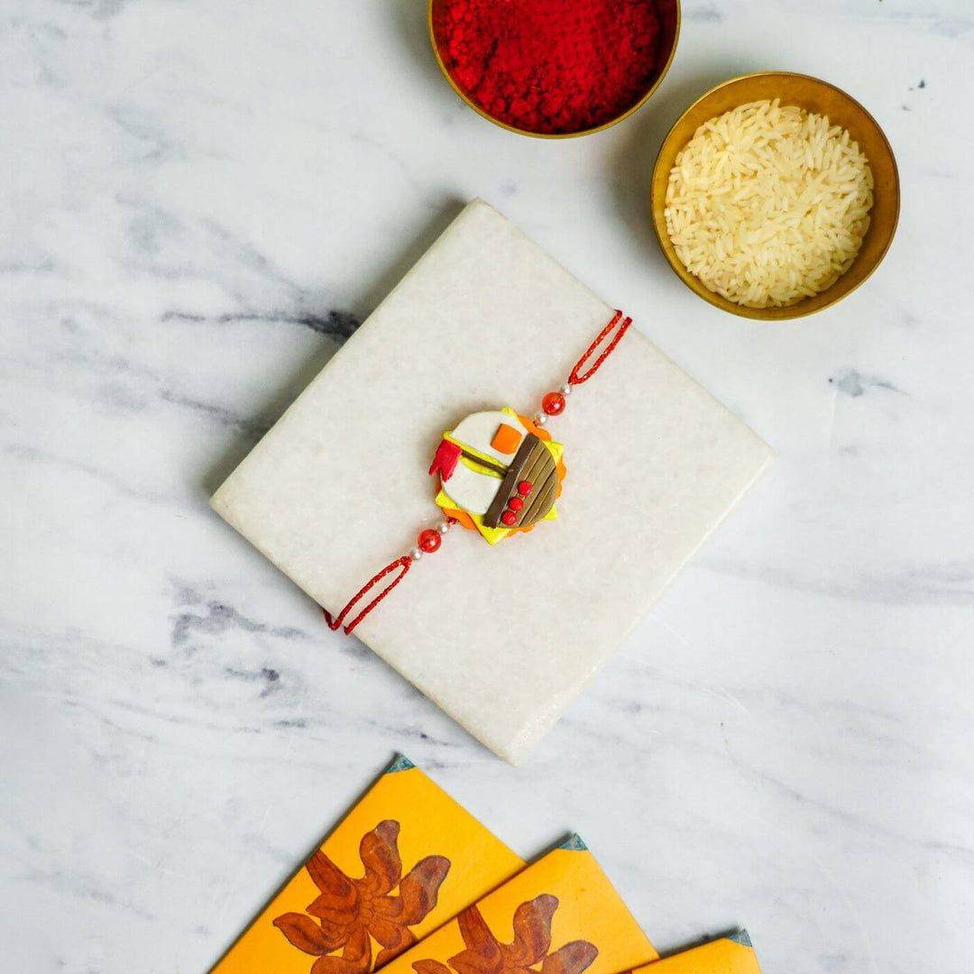 Handmade Porcelain Clay Themed Rakhi With Roli Chawal