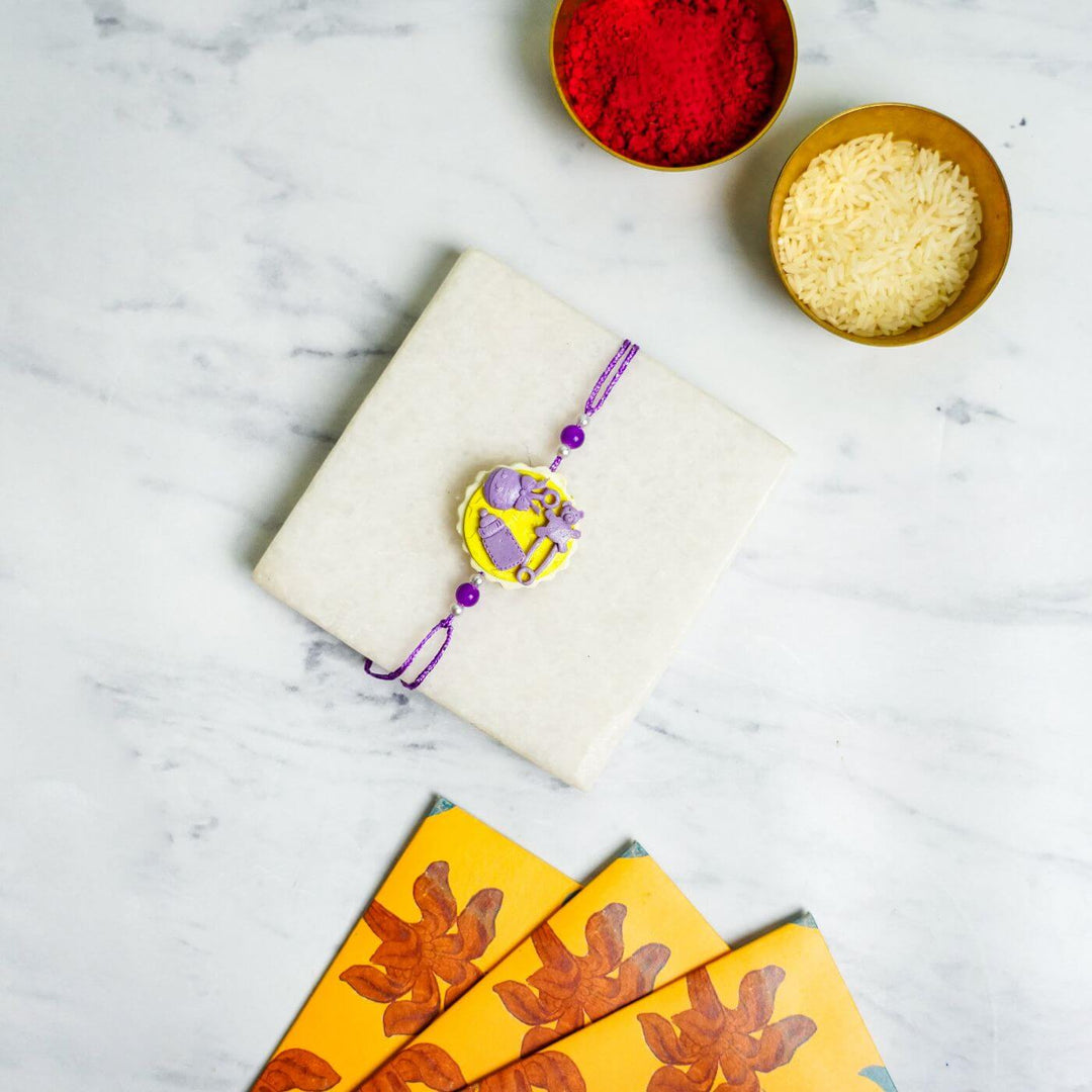 Handmade Porcelain Clay Themed Rakhi With Roli Chawal