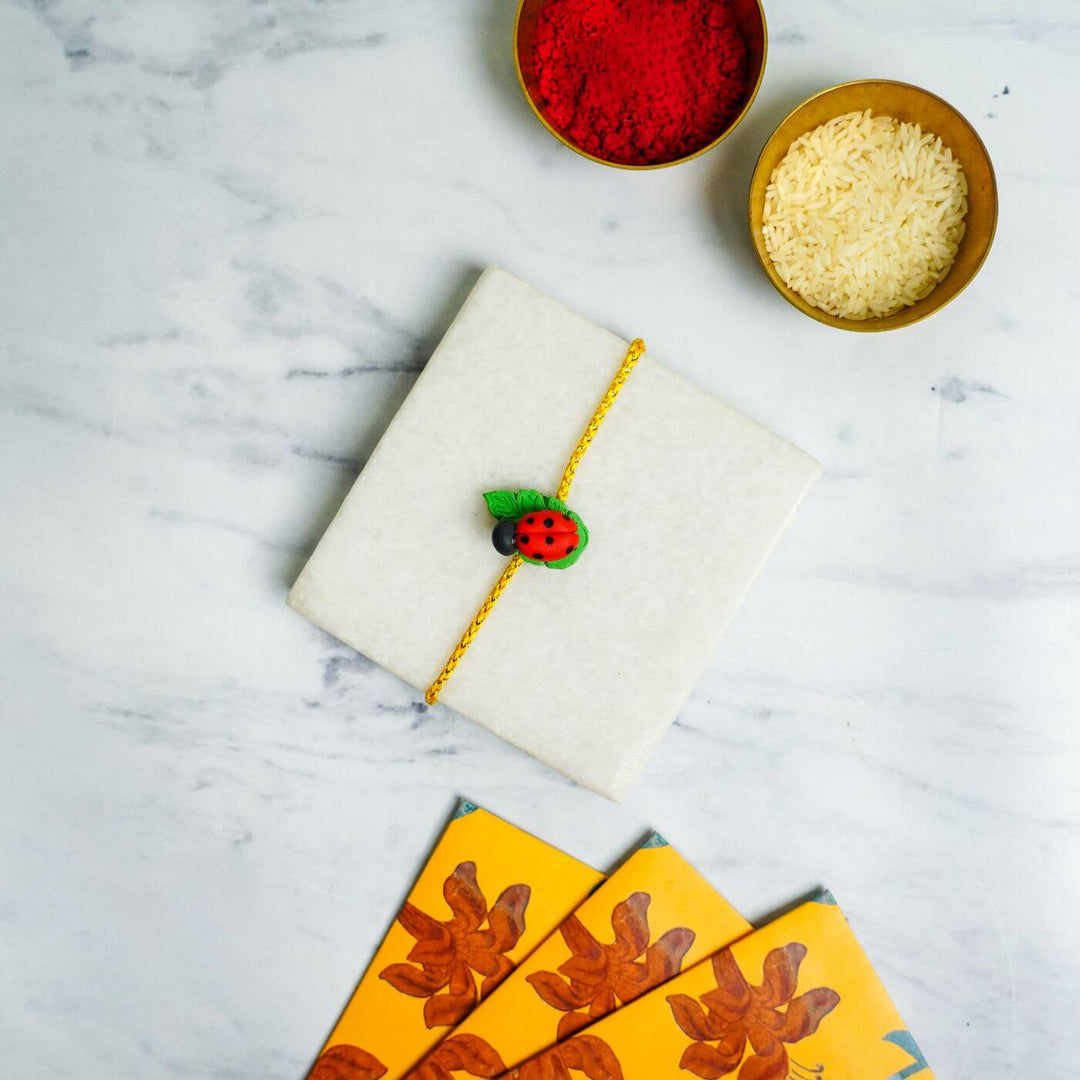 Handmade Porcelain Clay Themed Rakhi With Roli Chawal