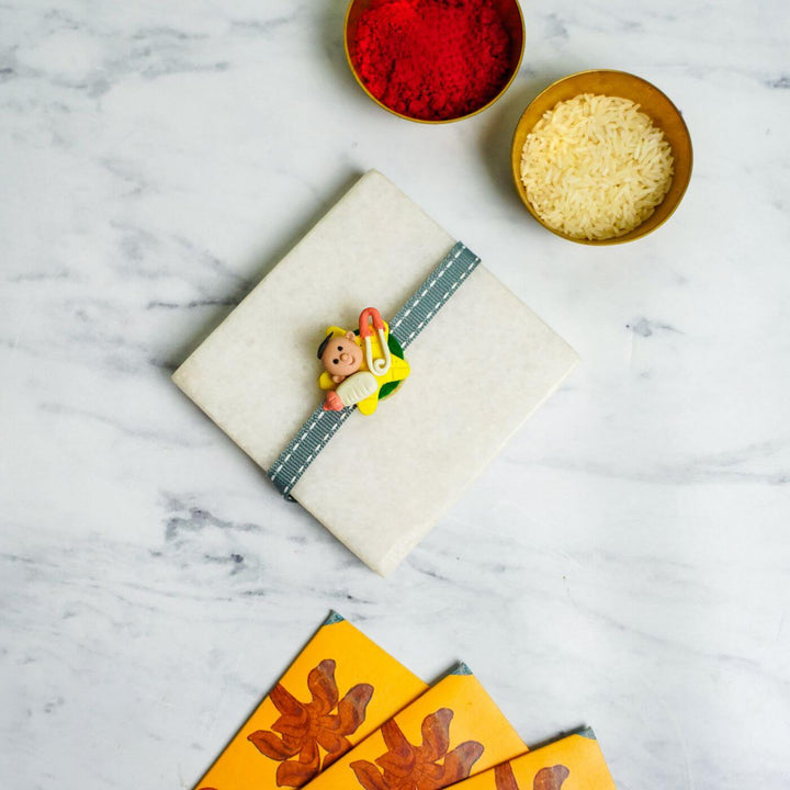 Handmade Porcelain Clay Themed Rakhi With Roli Chawal