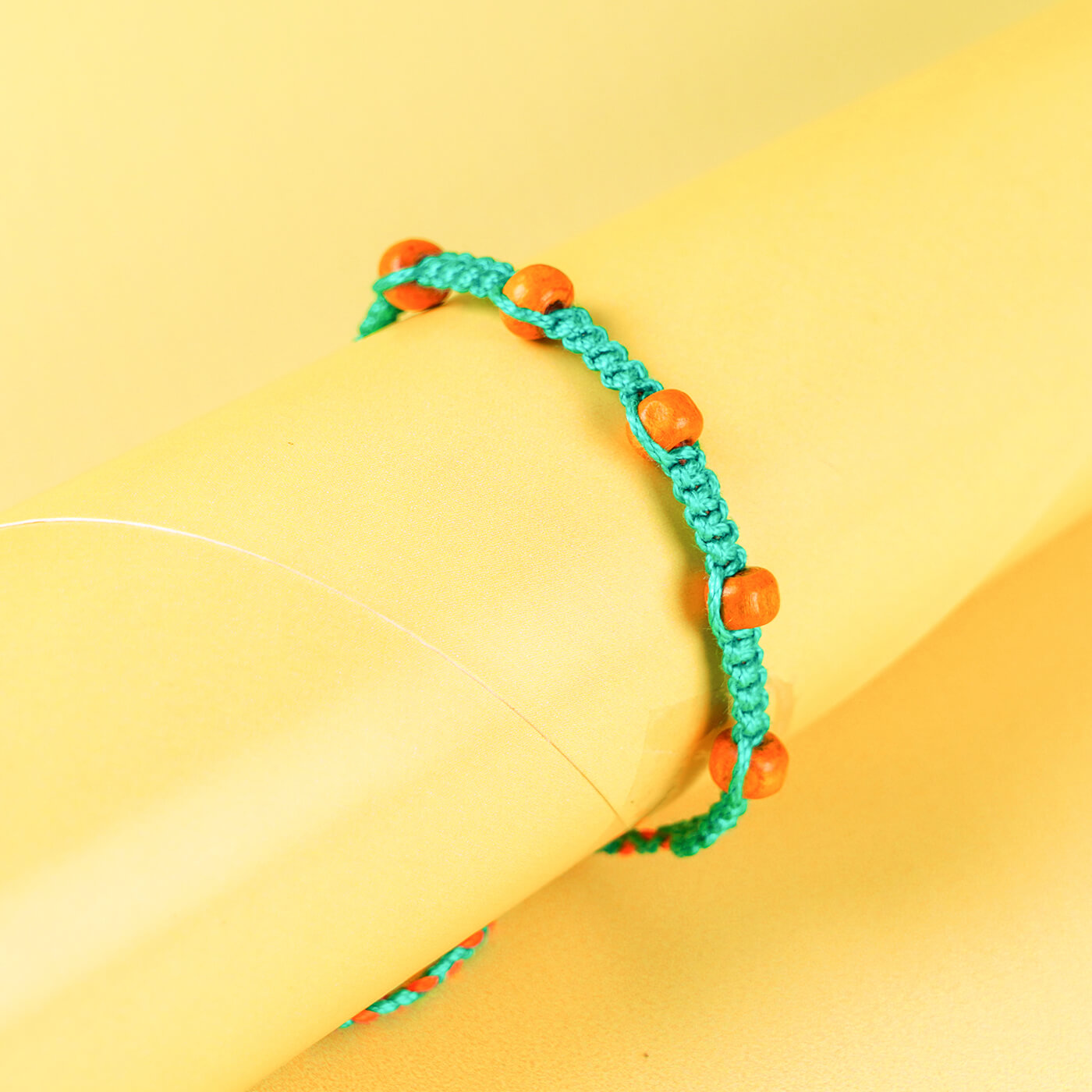 Buy Teal Macramé Cotton Rakhi With Orange Beads Online On Zwende